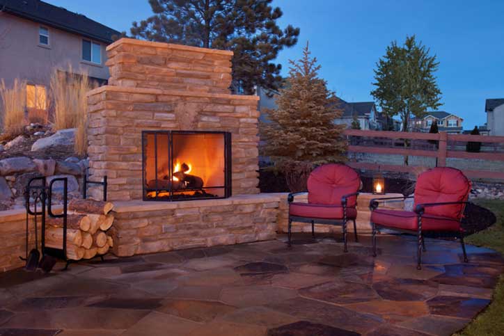 Outdoor patio with fireplace and lounging.